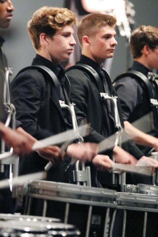 FAMILY — Bryce Dunn and Brendan Blanco stand with drumline, during the last performance of “Fortune Teller” at Gala. “Having the power and volume of performing in the auditorium is much different than performing on the field,” Dunn said. 