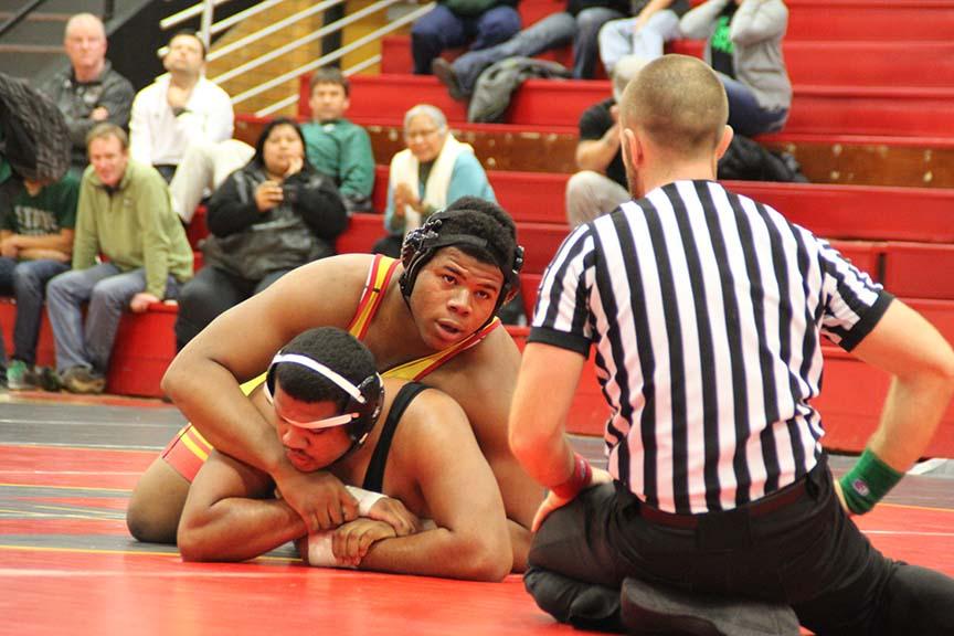 Maneuvering a cross face, senior Alex Jones gains wrist control over his opponent at a home meet earlier this season. Jones won the 285-pound state championship on March 1.
