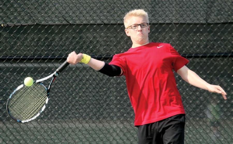Returning a lob, sophomore Elliot Abromeit prepares to score a point in a singles match at Free State on April 15.