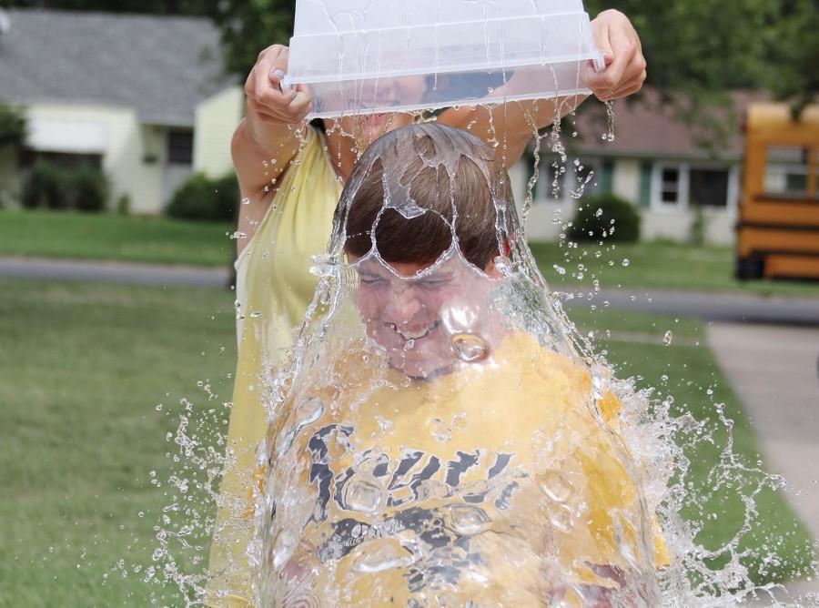Cringing as water cascades over his head, sophomore Cole Herrin took the ALS Ice Bucket Challenge during the school day.