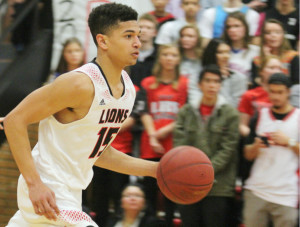 Lawrence High alum Anthony Bonner brings the ball up the court during his senior season at home against Free State. 