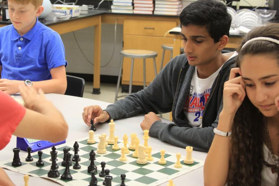 Holding his opponent’s pawn in one hand, senior Kaustubh Nimkar contemplates his next move during a fall chess club meeting in sponsor Andrew Bricker’s classroom.
