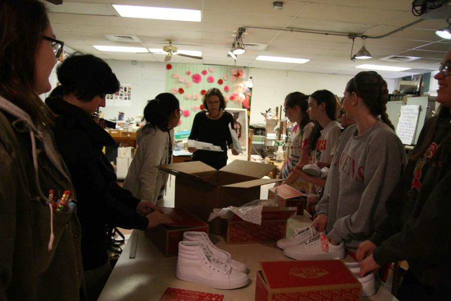 Class winners of each contest category met in Wendy Vertacnik’s classroom after school on March 2 to unbox the Vans canvas shoes they will paint their designs on. “I think this will be fun,” said Katie Grear, who won first place in the Action Sports category. “I’m not used to sharing ideas with other people. It will probably be good for team building.”
