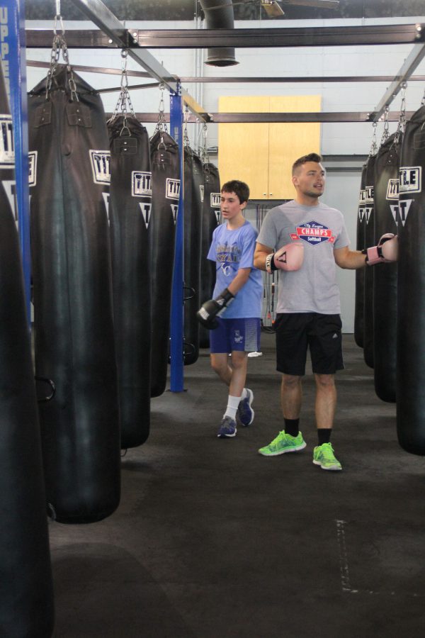Security guard Michael Anderson instructs boxing students at Uppercut Fitness on Saturday, April 30.