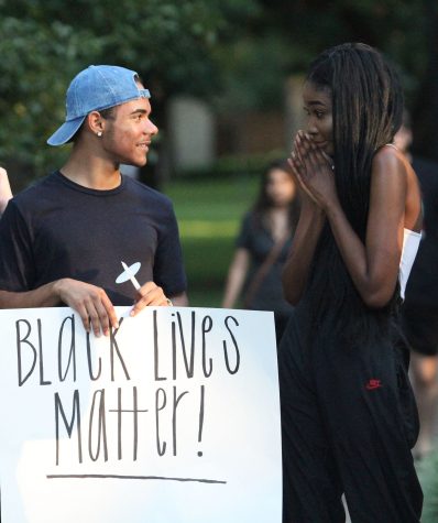 Showing support— Junior Avery Mulally and senior Janada Birdling spread the message of Black Lives Matter at the candlelit vigil held at South Park on July 10.