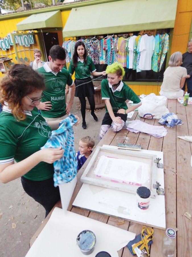 creating — Seniors Allie Fischer and Toby Weston screenprint T-shirts at the Percolator as part of their show. 