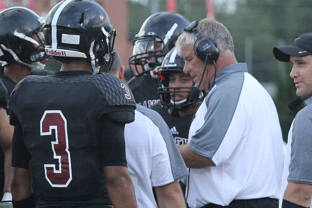 Coach Dirk Wedd meets with players during the Sept. 9, 2016, LHS football game.