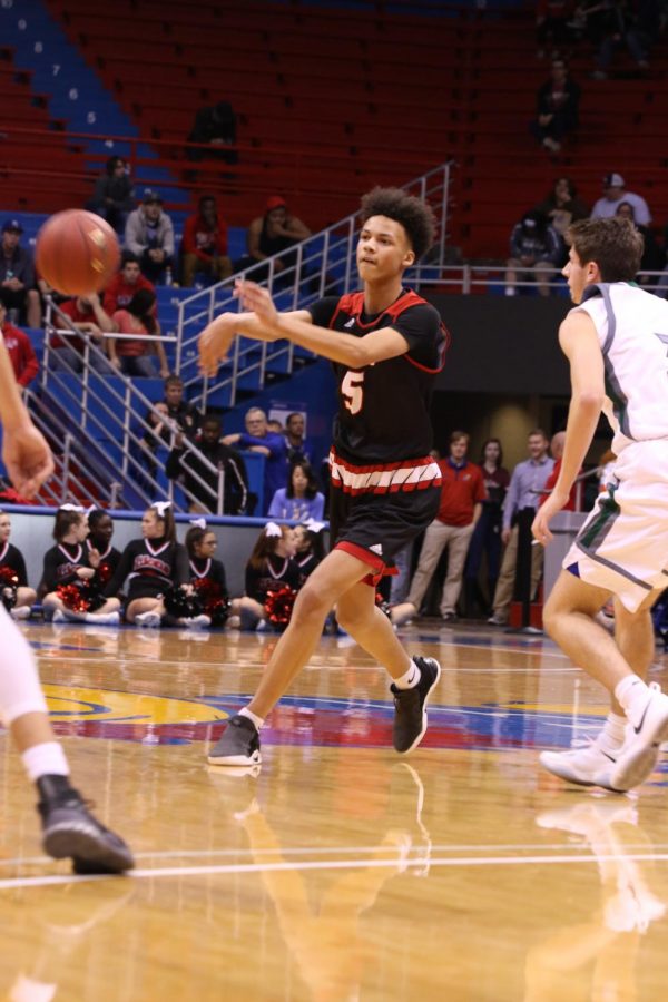 Freshman Zeke Mayo sprays it out to a teammate on Friday night vs. Free State at Allen Fieldhouse. Mayo would finish with 7 points.