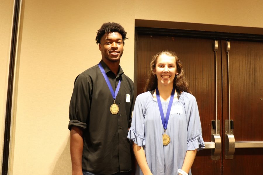 Eric Galbreath (left) and Evann Seratte (right) stand for a picture at the Community Education Breakfast on September 7. The two seniors won the Student Champion Award.