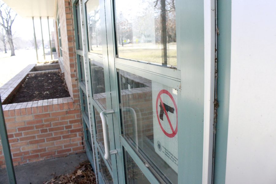 This side entrance to Lawrence High School includes a no weapons sign.