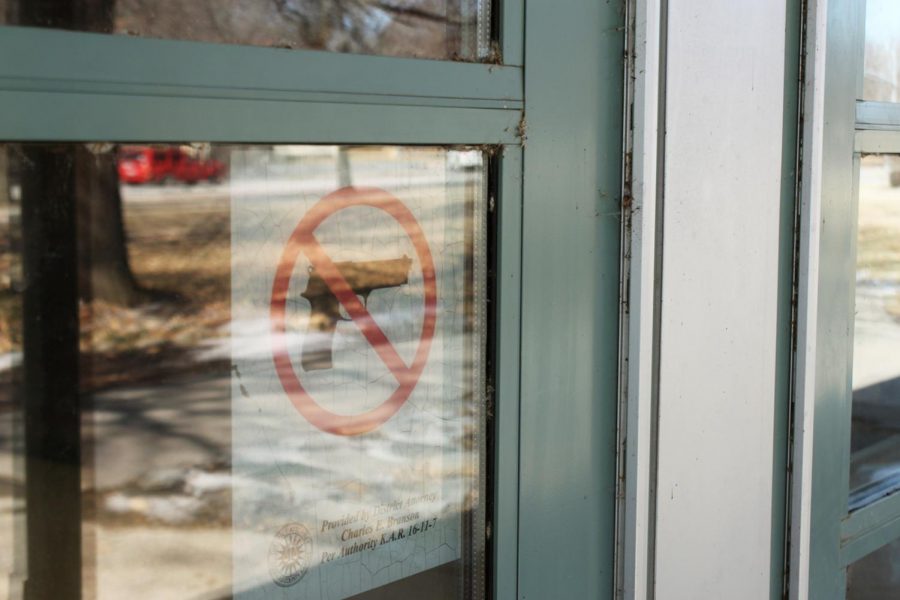 An outside entrance to Lawrence High School notes that guns are not allowed inside the building.