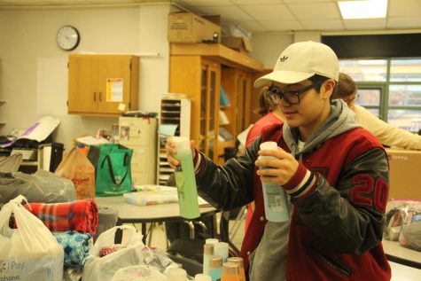 Junior Josh Sanchez helps pack donations for the Navajo Nation of Arizona and the Pine Ridge Indian Reservation of South Dakota reservations during an Inter-tribal Club meeting.
