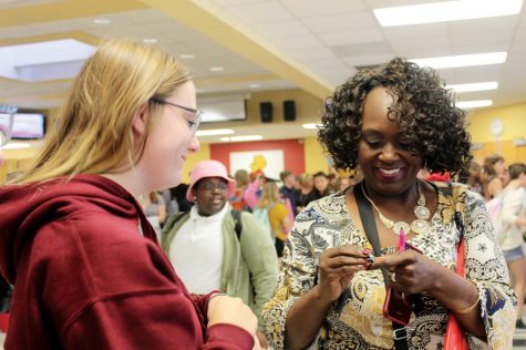 At the Club Fair on Aug. 26, senior Megan Drumm gives interim principal Cynthia Johnson a pin reading “You put the pal in principal.” Drumm got the pin on a visit to the Herff Jones yearbook plant earlier that day. “I saw the pin and immediately thought of Mama J,” Drumm said.