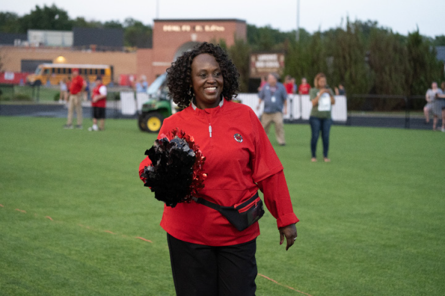 Loud and Proud - Ready for the rivalry  football game, Principal Cynthia Johnson flashes a smile at the Lawrence High vs. Free State City Showdown on Sept. 27.