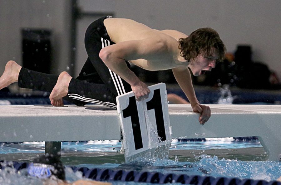 Counting on, junior Tyler Jones cheers on his teammate Max Cowardin (freshman) as he counts for his 500 freestyle. After competing in prelims, Cowardin was in 8th place. In the finals, Cowardin moved up two spots and finished in 6th place.