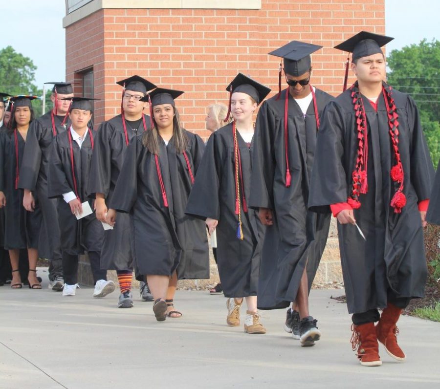 Walking into the stadium, members of the class of 2018 attend their graduation. Two years later, members of the class of 2020 may finally get to take that same walk — or something similar — during a graduation ceremony planned for July. Graduation was delayed due to COVID-19.