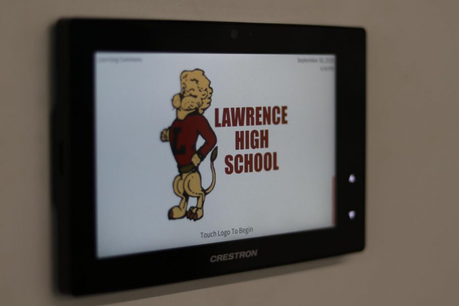 A touchscreen panel controls a projector and screen in a new learning space.