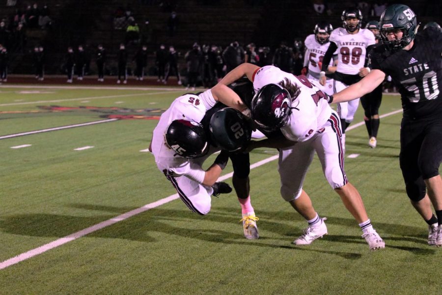 Two-man team, senior Jack Stoll and junior Jackson Wood take down Free States ball carrier during the third quarter. 