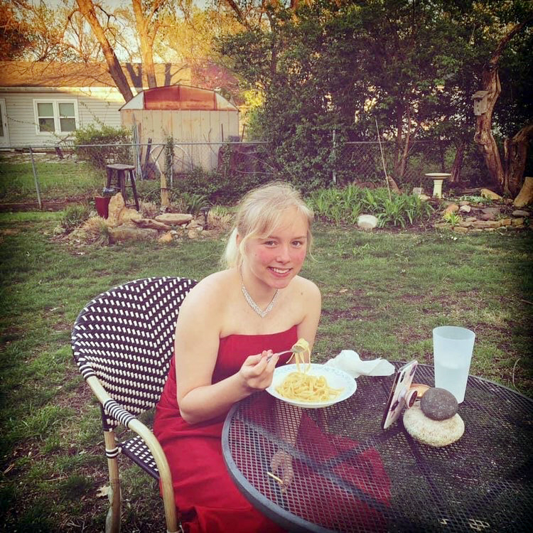 In 2020, students had to make due with at-home proms. This year, theyll be able to celebrate in person. In this 2020 photo, Rose Hicks dines on chicken alfredo before her virtual prom.