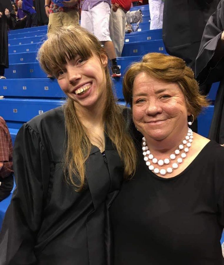Lawrence High para educator poses for a photo with LHS graduate Cheyenne Graham at a graduation ceremony.