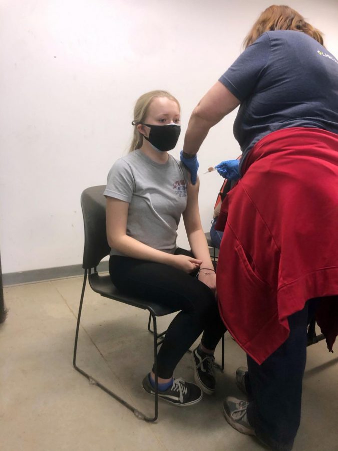 Senior Kenna McNally receives the second dose of the Pfizer vaccine on March 26. Pfizer is approved for ages 16 and up. McNally received her first shot after volunteering a county vaccination clinic at the Douglas County Fairgrounds.