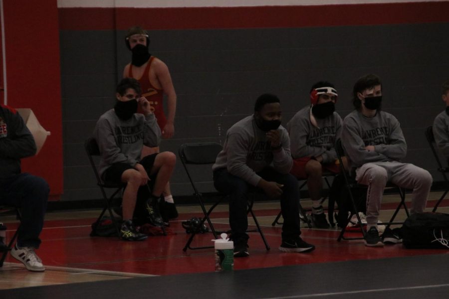 Members of the wrestling team watch intensely during a meet at Lawrence High versus Washburn Rural on January 27. 