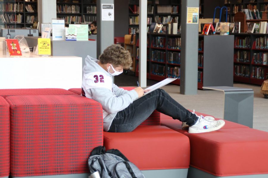  Enjoying the new space,
junior Brayden Heck works on an assignment in the atrium.“Sometimes the football players get sandwiches and eat out in the courtyard...It’s a really nice area.”