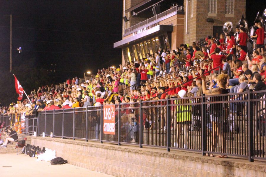 Fans pack the stands on the east side of the stadium during the football teams first home game.