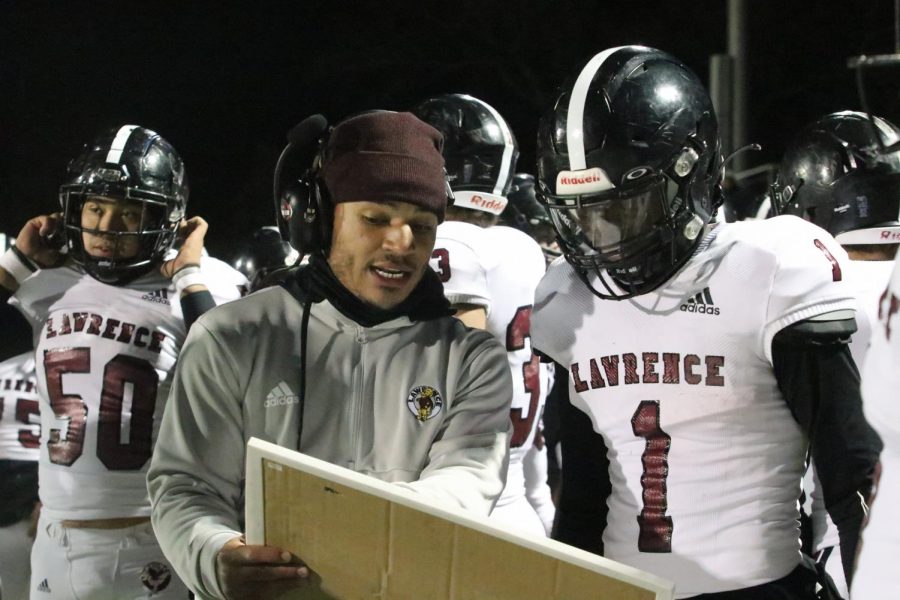 Senior Avion Nelson receives coaching advice from first-year assistant Bryce Torneden. 