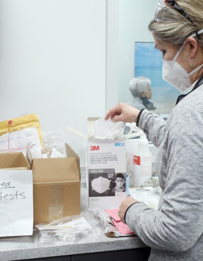 A few days after returning for second semester, school nurse Carol Casteel goes through N95 masks, which more students and faculty have begun wearing since returning from winter break when the spread of COVID-19 spiked.