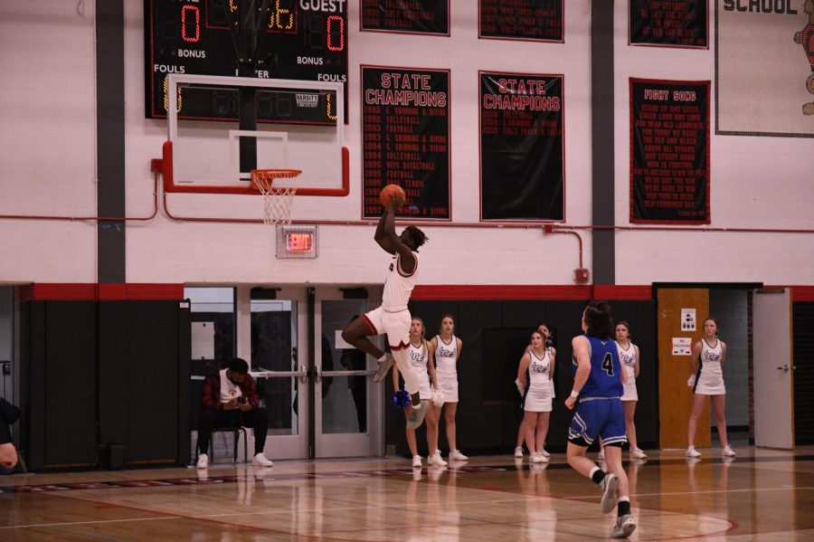 Senior Avion Nelson rises up for a dunk on January 28 in a 59-29 victory over the Gardner Edgerton Trailblazers. 