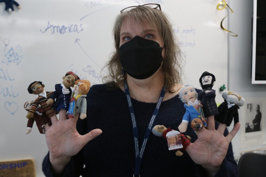 Eight to a hand, teacher Valerie Schrag shows off her collection of finger puppets of historical figures. “It just became kind of this silly little thing,” Schrag said. “It is completely silly and absurd, and it is the best thing ever.” 
