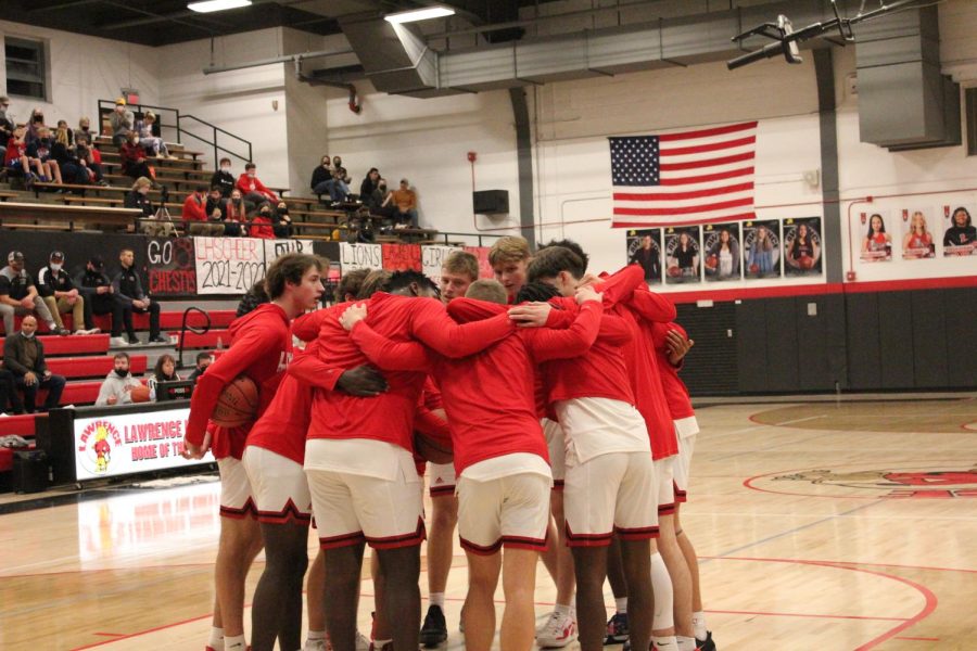 The Lions huddle awaiting the start of a home contest versus Olathe West on January 4. 