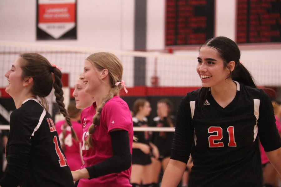 The varsity volleyball team celebrates after winning a point during their match on October 4th. 