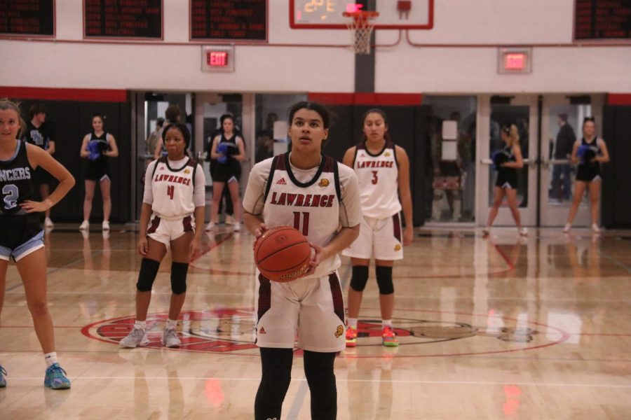 Junior Brynae Johnson prepares to shoot a free throw amidst during their game against Shawnee Mission East.