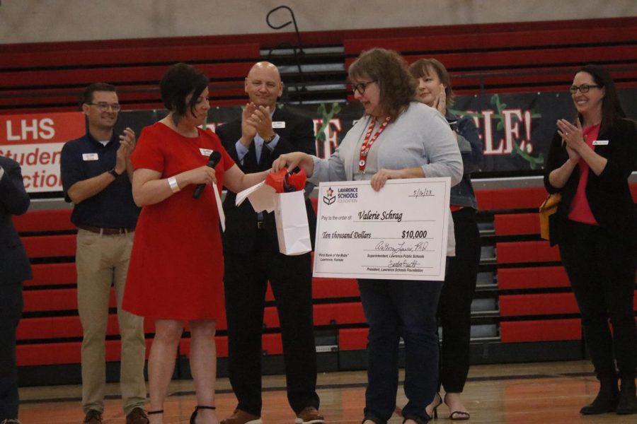 Teacher Valerie Schrag receives her $10,000 check for winning the Bobs Award, a teaching recognition funded by a group of local donors all named Bob.