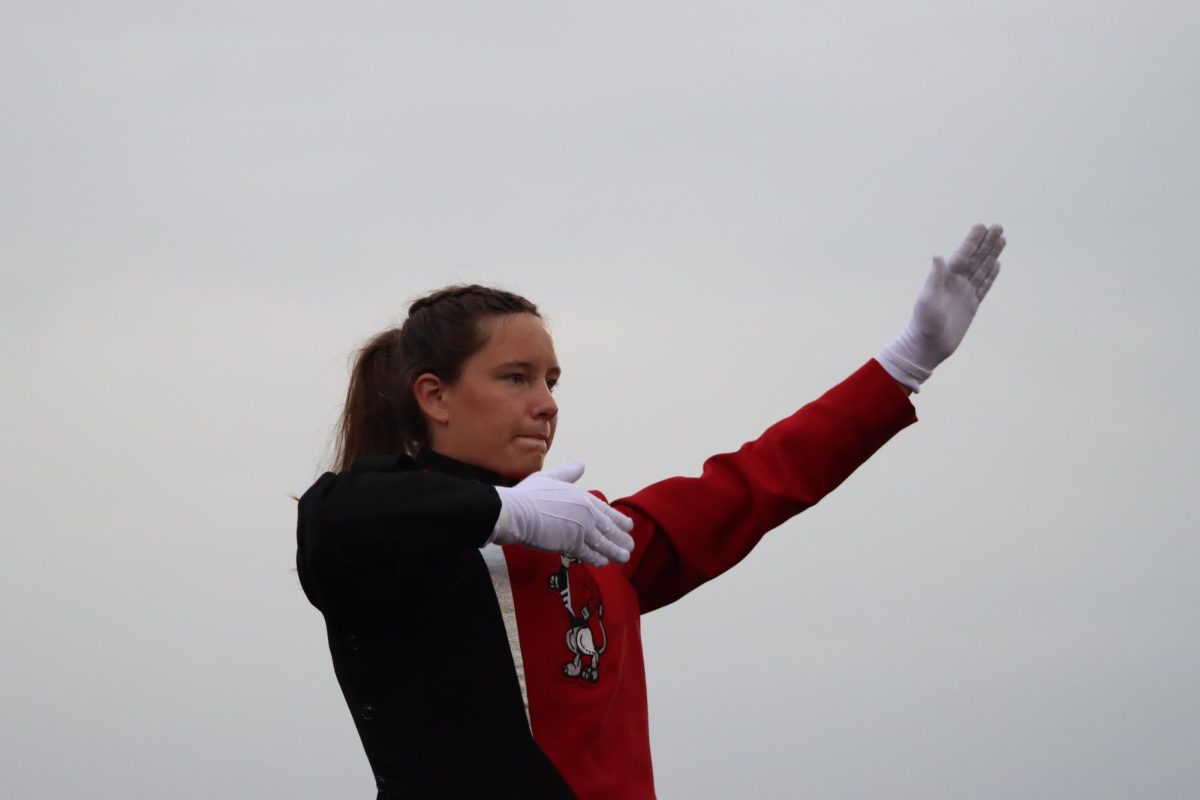 Junior Morgan Moeckly conducts the marching band at the home football game on September 15th. 