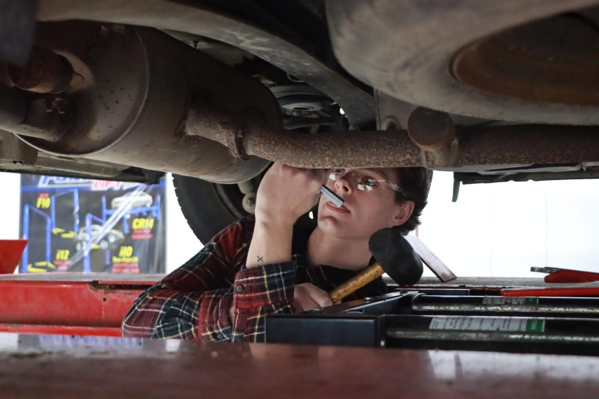 Senior Colin Sandefur checks the joint for exhaust leaks during the Auto/Welding for the Novice course at Peaslee Tech.