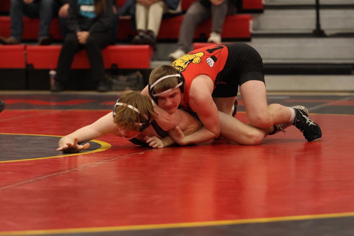 Senior Andrew Honas pins his opponent during a meet on January 24th at home.   