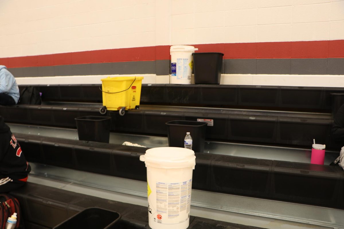 Containers have been placed in the west gym to catch leaking roof water.
