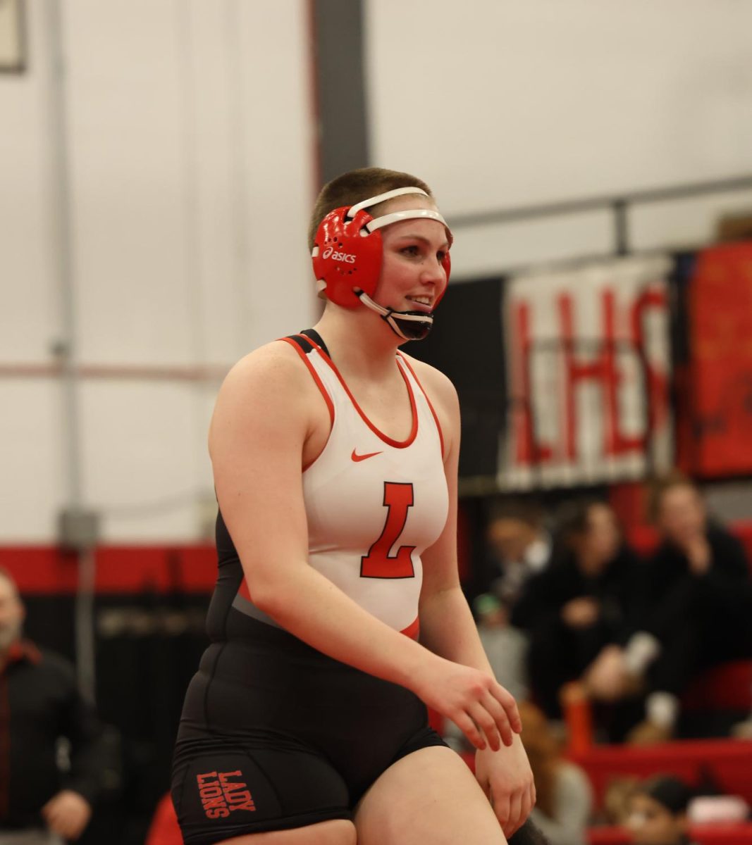 Smiling, Junior Goldy Stephens walks off the mat after a successful match on Feb. 5th. 